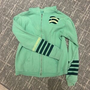 Free City. Green zip up hoodie. Missing drawstring.